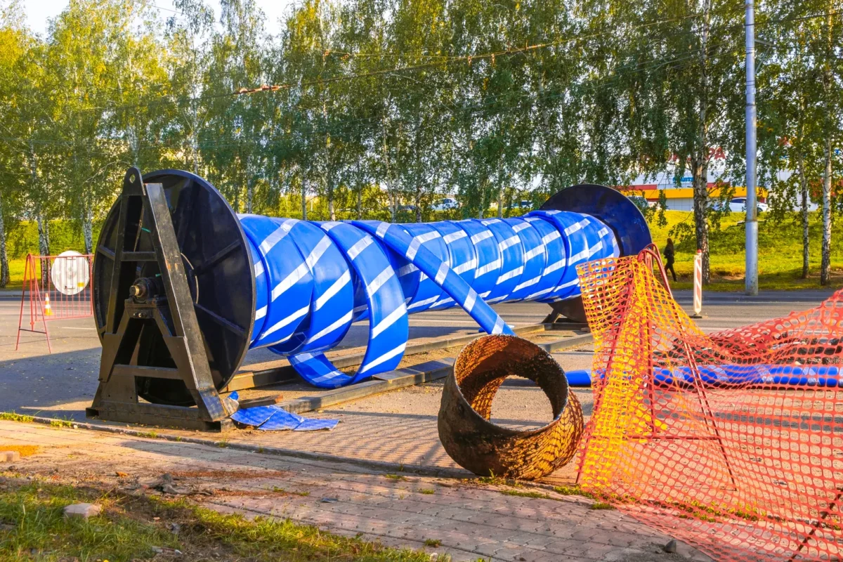 Folded blue pipe on a reel for trenchless pipeline renovation.